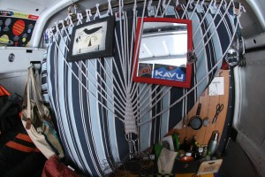 Space-saving multipurpose in WallE. $10 Hammock covers storage, provides hanging space with shower curtain hooks at top - AND - clips to the back of the van for a second bed.